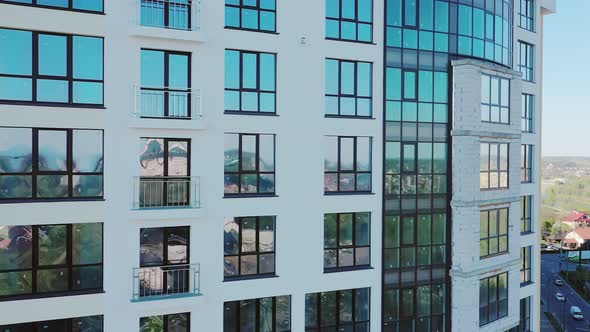 Many windows on new apartment building facade under construction. Real estate development