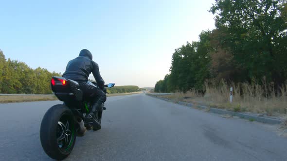 Follow to Motorcyclist in Helmet Riding on Sport Motorbike at Highway