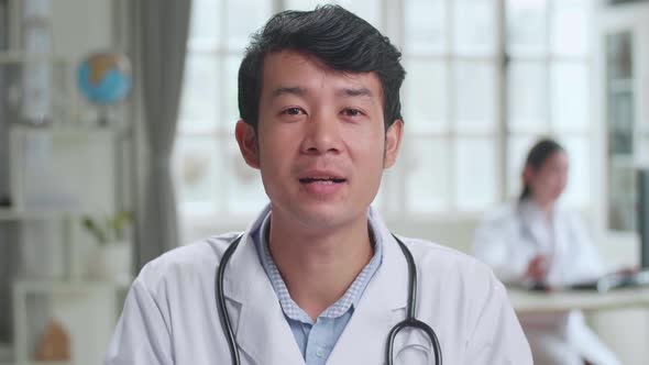 Male Doctor Physician In White Medical Uniform Speaking Looking At Camera Make Video Conference