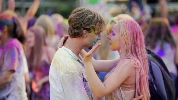 Happy Couple Flirting and Hugging Gently at Outdoor Concert, Dancing at Party