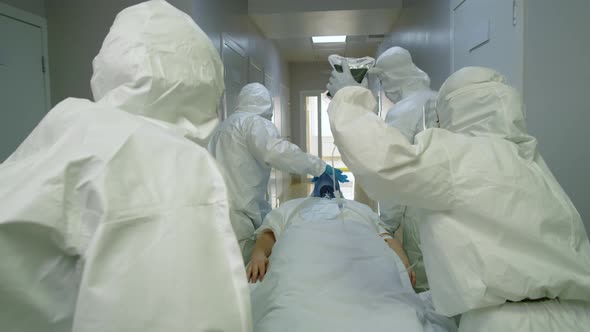 Paramedics in Protective Suits Transporting Covid-19 Patient