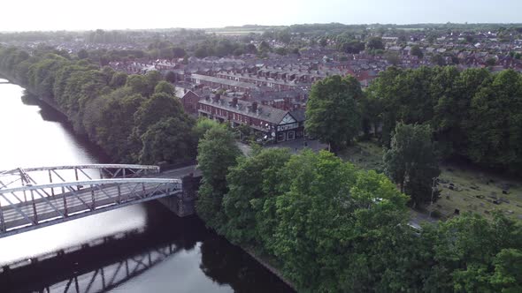 Aerial view Manchester ship canal swing bridge orbit across Warrington houses England