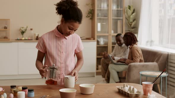 African girl Pouring Tea for Parents