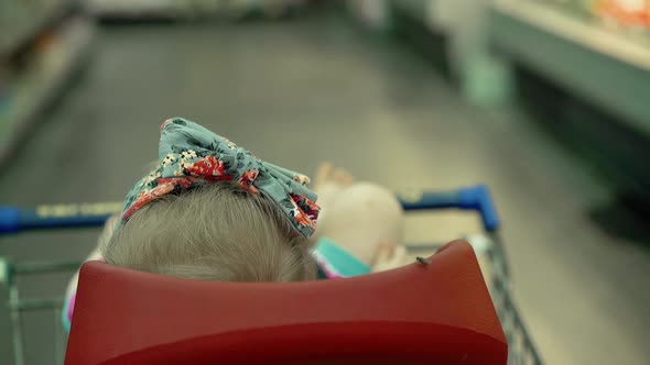 Child Sits in a Specially Equipped Chair 6 in the Supermarket 2