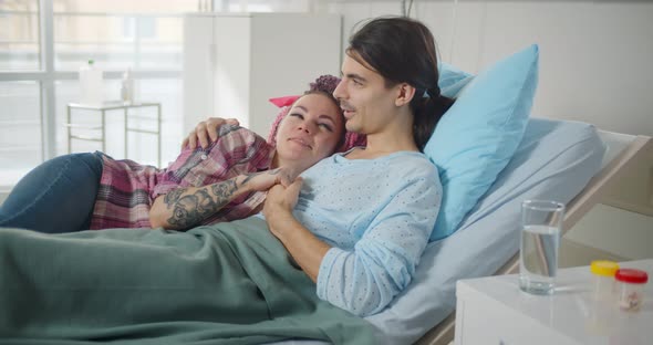 Young Wife Visiting Ill Husband in Hospital Room