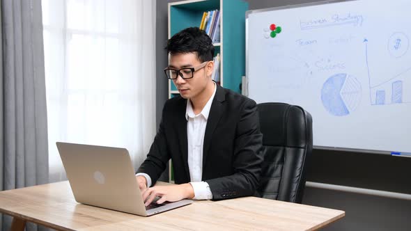 Asian Businessman Working With Computer