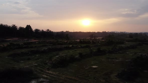 Deforest and exploitation of land during sunset