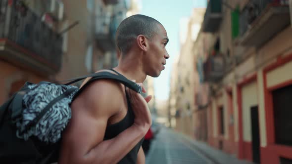 Bald handsome sportsman wearing black T-shirt walking