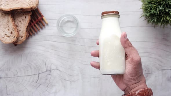 Hand Holding a Milk Jar Top View