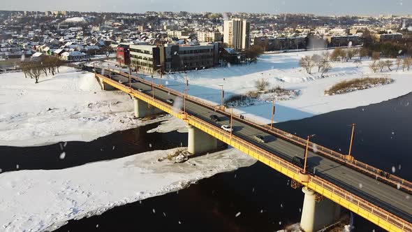 Vilijampole district and Vileisis bridge during snowstorm in Kaunas. Aerial drone view