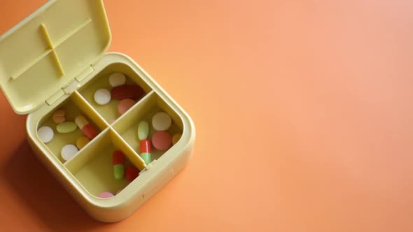 Close Up of Medical Pills in a Pill Box on Table