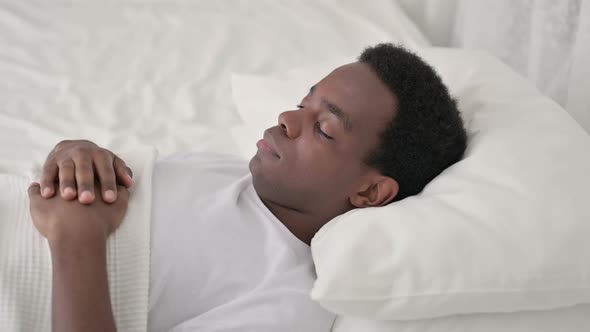 Sick African Man Coughing While Sleeping in Bed