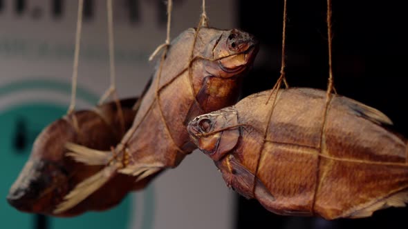 Salted Dried Cured or Smoked Sea Bream Fish Hanging in a Rope in the Street Food Market Place