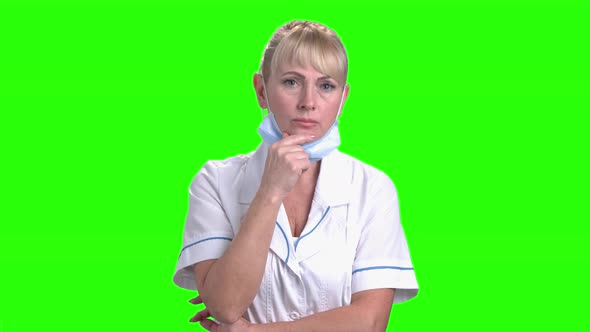 Thoughtful Female Doctor on Green Screen.