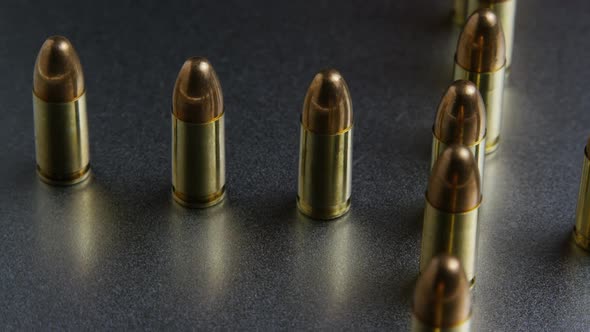Cinematic rotating shot of bullets on a metallic surface - BULLETS 