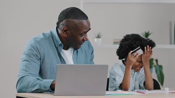 Mature Father with Little Daughter Making Purchases on Internet Using Laptop Paying for Order