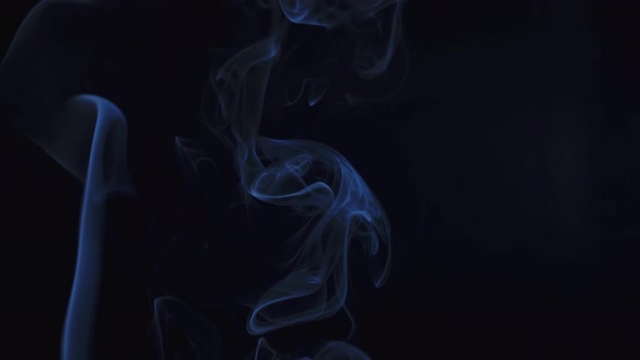 Abstract Smoke Cloud. Blue Smoke Slowly Floating Through Space Against Black Background. Close Up