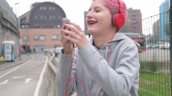 Young woman listening music using smartphone