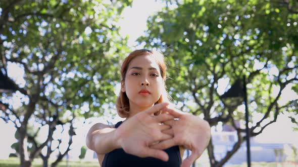 Young Woman Stretching Arms