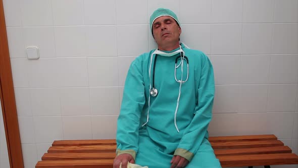 Exhausted surgeon sitting on a bench