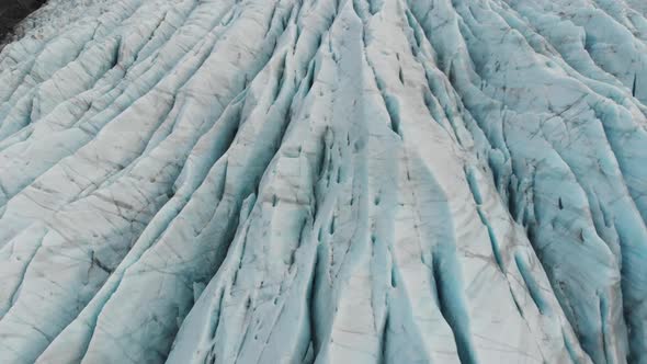 Glacier in Highlands of Iceland, Birdseye Aerial View of Blue Ice. Global Waming and Climate Change