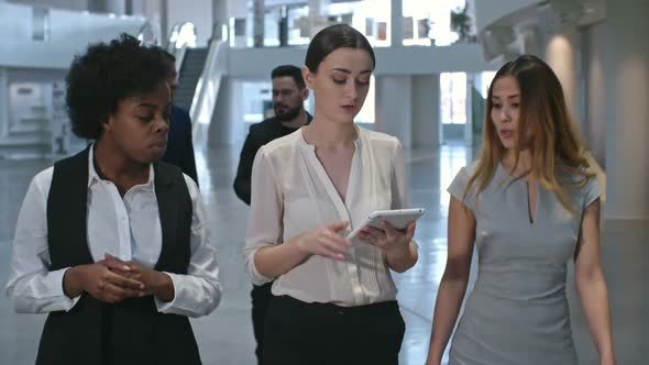 Businesswomen Walking and Discussing Work