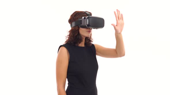 Young Businesswoman is Working Using Virtual Reality Glasses and Making Hand Gestures Isolated Over