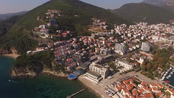 Panoramic View of New and Old Houses in Budva Against the Backdrop of Green Mountains