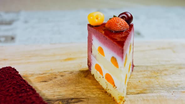 A Slice of Cake with Strawberries and White and Red Cherries