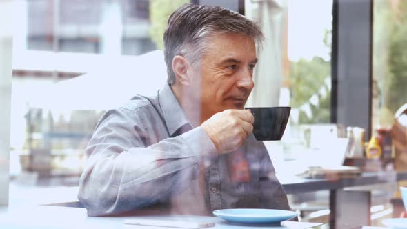 Businessman discussing with colleague in office cafeteria