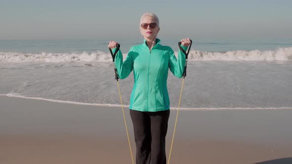 Senior Woman Exercising At The  Beach