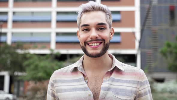 Portrait of Young Happy Handsome Gay Man with Beard and Makeup in Eyes and Lips