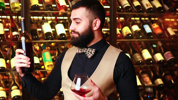 Arabian Man Sommelier Appreciating Drink in Lux Hotel