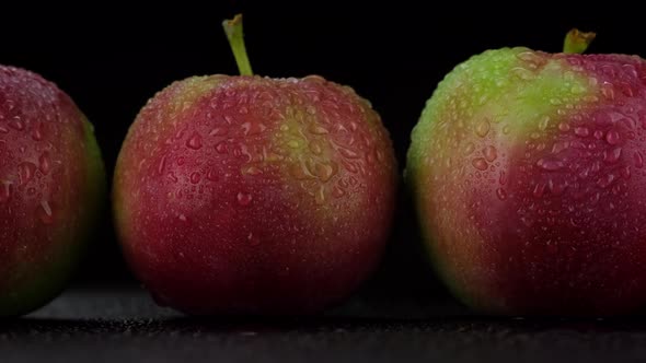 Fresh apples close up on black background. Sliding shot. 4K UHD video
