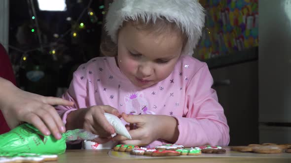 Girl Paints Christmas Cookies.