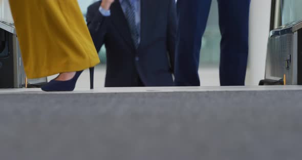 Business people on an escalator in a modern building