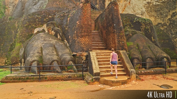 4K Tourist Climbing the Lion's Paw Staircase Entrance to the Sigiriya Fortress, Sri Lanka