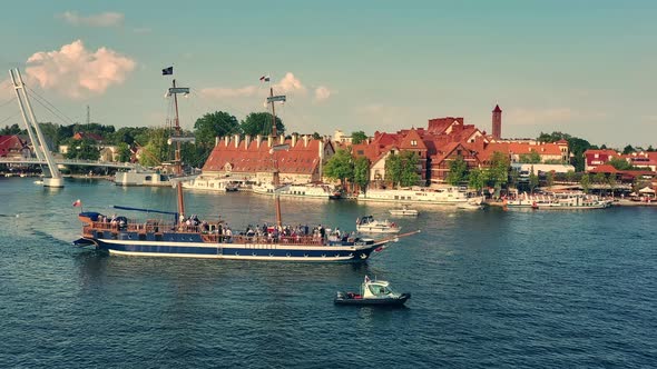 Drone view on a sailing boat floating along the lake in the city of Mikołajki.