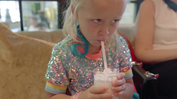 Kid Drinking Delicious Milkshake in Cafe