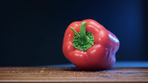 Red Bell Pepper Falls on Brown Wooden Board in Restaurant