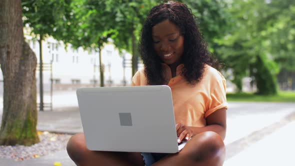 African Student Girl with Laptop in City