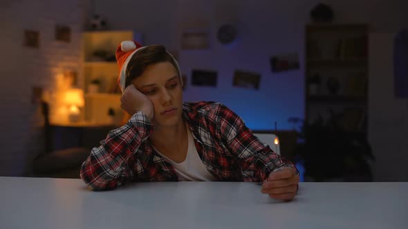 Lonely Depressed Teenager in Santa Hat Celebrating New Year Holding Bengal Light