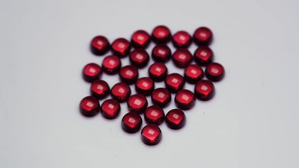 Natural Red Garnet Gemstone on the White Background on the Turning Table