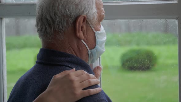 Woman Puts Her Hand On The Shoulder Of An Elderly Man Family Support And Care