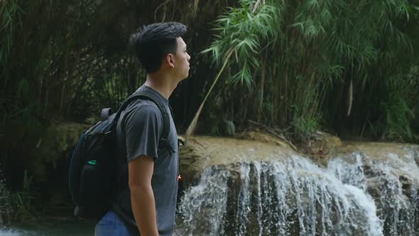 Male Standing Near Waterfall