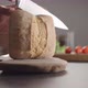 Man Slicing Small Ciabatta Bun for Sandwich on Kitchen Countertop - VideoHive Item for Sale