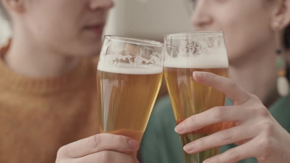 Man and Woman Making Sip of Beer in Cafe
