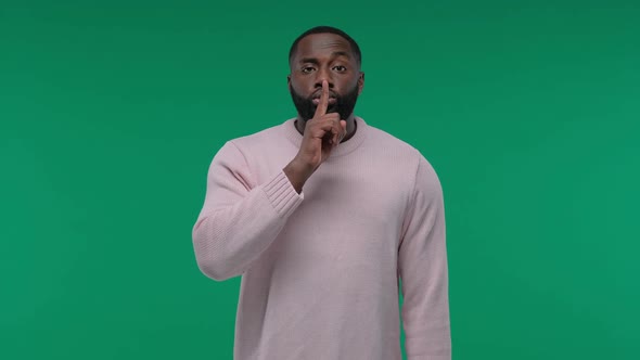 African American Man Showing Hush Gesture Isolated on Green Screen, Chroma Key Background, Keeping