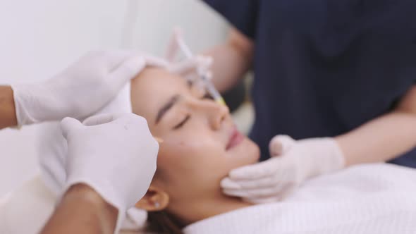 Beauty clinic concept. Young woman getting professional facial procedure.