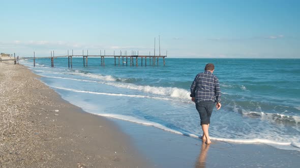 Man Walking on the Beach